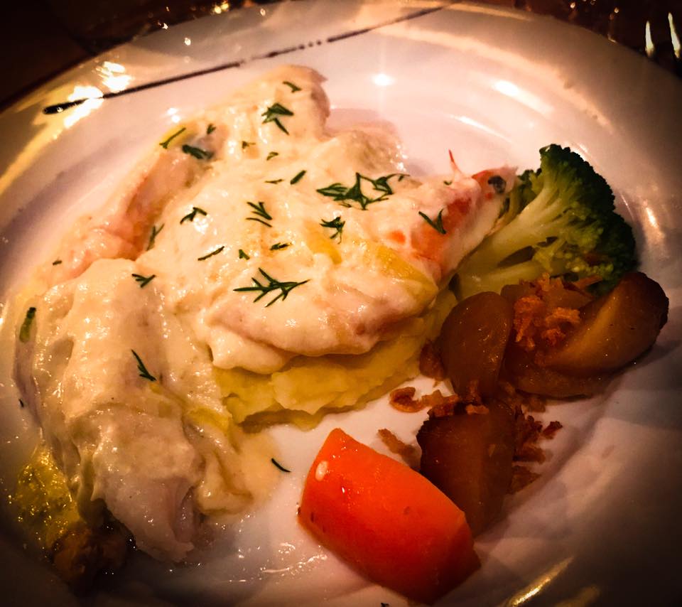 Medium rare Salmon, Cod and Shrimp in a Creamy Leek Sauce over mashed potatoes 